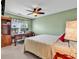 Cozy bedroom featuring a ceiling fan, neutral carpet, a desk and built-in shelving at 604 Wilshire Ln. # 604, Murrells Inlet, SC 29576