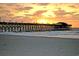 Beautiful beach at sunset with a pier in the background at 627 N Waccamaw Dr. # 203, Murrells Inlet, SC 29576