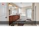 Bathroom with dual sinks, a walk-in shower, and a soaking tub with wooden cabinets at 632 Serendipity Circle, Murrells Inlet, SC 29576