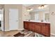 Double vanity bathroom with decorative mirrors, neutral paint, and tile flooring at 632 Serendipity Circle, Murrells Inlet, SC 29576