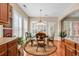 Open concept dining area featuring a round dining table and plantation shutters at 632 Serendipity Circle, Murrells Inlet, SC 29576