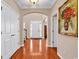 Welcoming foyer with hardwood floors, arched doorways, and a decorative front door, setting a tone of refined elegance at 632 Serendipity Circle, Murrells Inlet, SC 29576