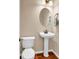 Cozy half bath featuring a pedestal sink and classic fixtures, providing convenience and charm for guests at 632 Serendipity Circle, Murrells Inlet, SC 29576