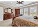 Well-lit bedroom featuring a decorative bed, large windows, and matching wooden furniture at 632 Serendipity Circle, Murrells Inlet, SC 29576