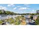 Aerial view of condo buildings, car parking, landscaping, and community pool at 679 Riverwalk Dr. # 202, Myrtle Beach, SC 29579