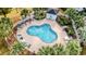 Overhead shot of the community pool surrounded by palm trees, lounge chairs, and a pool house at 679 Riverwalk Dr. # 202, Myrtle Beach, SC 29579