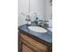 Classic bathroom vanity with a dark countertop and decorative flower accents, exudes cleanliness at 679 Riverwalk Dr. # 202, Myrtle Beach, SC 29579