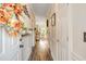 Inviting hallway with dark wood flooring and trim, leading into the open-concept kitchen and dining area at 679 Riverwalk Dr. # 202, Myrtle Beach, SC 29579