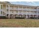 Charming condo exterior with brick accents, offering classic appeal and well-kept landscaping at 679 Riverwalk Dr. # 202, Myrtle Beach, SC 29579