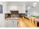 Charming kitchen with butcher block counters, stainless appliances, a stone backsplash, and white cabinets at 679 Riverwalk Dr. # 202, Myrtle Beach, SC 29579