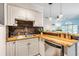 Bright kitchen with butcher block counters, stainless appliances, stone backsplash and open to the living room at 679 Riverwalk Dr. # 202, Myrtle Beach, SC 29579
