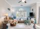 Open concept living room featuring a blue accent wall, a ceiling fan, and a large window at 679 Riverwalk Dr. # 202, Myrtle Beach, SC 29579
