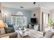 Bright open living room with large windows, sliding door and neutral furniture at 679 Riverwalk Dr. # 202, Myrtle Beach, SC 29579