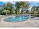 Outdoor community pool surrounded by lounge chairs, palm trees, and a white picket fence at 679 Riverwalk Dr. # 202, Myrtle Beach, SC 29579