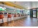 Spacious bar area with multiple stools, countertops, modern lighting, and poolside views at 7200 Ocean Blvd. N # 664, Myrtle Beach, SC 29572