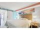 Bright bedroom featuring a sliding barn door, serene artwork, and beachy decor at 7200 Ocean Blvd. N # 664, Myrtle Beach, SC 29572