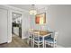 Dining area featuring a table with four chairs, light fixture and a view into the kitchen at 7200 Ocean Blvd. N # 664, Myrtle Beach, SC 29572