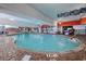 An inviting indoor swimming pool with a brick border offering a relaxing space for recreation and exercise at 7200 Ocean Blvd. N # 664, Myrtle Beach, SC 29572