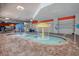A shallow pool features umbrella waterfalls, set inside with a brick-trimmed edge, and colorful decor at 7200 Ocean Blvd. N # 664, Myrtle Beach, SC 29572