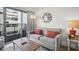 Inviting living room with a gray sofa, balcony access, and shiplap walls for a cozy beachy feel at 7200 Ocean Blvd. N # 664, Myrtle Beach, SC 29572