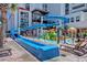 Resort waterpark with a winding waterslide, fun water features, and lounge chairs for relaxation at 7200 Ocean Blvd. N # 664, Myrtle Beach, SC 29572