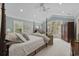 Spacious bedroom with high ceilings, lots of natural light, and a seating area by a large window at 741 Tuckers Rd., Pawleys Island, SC 29585
