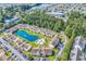 Extensive aerial view of a community with a lake and a pool, surrounded by residential buildings and lush greenery at 8570 Hopkins Circle # D, Surfside Beach, SC 29575