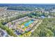 Sprawling aerial view of a neighborhood with tree-lined streets and amenities, featuring a lake and a pool at 8570 Hopkins Circle # D, Surfside Beach, SC 29575