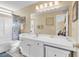 Clean and spacious bathroom featuring a large mirror, shower, and a spacious countertop at 8570 Hopkins Circle # D, Surfside Beach, SC 29575