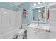 Clean bathroom with white fixtures, bathtub and shower combination, and a mirrored vanity at 8570 Hopkins Circle # D, Surfside Beach, SC 29575