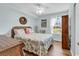 Serene bedroom featuring coastal decor, a ceiling fan, and ample natural light from the window at 8570 Hopkins Circle # D, Surfside Beach, SC 29575
