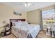 Comfortable bedroom with a beach themed comforter and large window view at 8570 Hopkins Circle # D, Surfside Beach, SC 29575