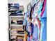 A walk-in closet filled with colorfully stacked clothing on shelves and hanging on racks at 8570 Hopkins Circle # D, Surfside Beach, SC 29575