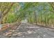 Tree lined driveway showcases the beautiful greenery and leads to the community at 8570 Hopkins Circle # D, Surfside Beach, SC 29575