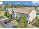 Exterior unit shows the well-manicured landscaping, neutral siding, parking, and serene pond view at 8570 Hopkins Circle # D, Surfside Beach, SC 29575