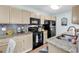 Bright kitchen features granite countertops, neutral cabinets, and black appliances at 8570 Hopkins Circle # D, Surfside Beach, SC 29575