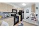Bright kitchen features granite countertops, neutral cabinets, and black appliances at 8570 Hopkins Circle # D, Surfside Beach, SC 29575
