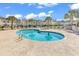 Exterior pool view shows the palm trees, lounge seating, and community buildings at 8570 Hopkins Circle # D, Surfside Beach, SC 29575