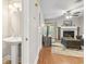 Cozy half bathroom with pedestal sink and light fixtures is conveniently located off of the living room at 86 Beaver Pond Loop # 33, Pawleys Island, SC 29585