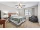This bedroom offers ample space, a wooden headboard, a ceiling fan, and lots of natural light at 86 Beaver Pond Loop # 33, Pawleys Island, SC 29585