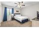 Cozy bedroom with natural light, carpet, and a comfortable bed with blue curtains at 86 Beaver Pond Loop # 33, Pawleys Island, SC 29585