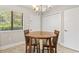 Intimate dining area featuring a round table with seating for four, nestled next to a window and closet at 86 Beaver Pond Loop # 33, Pawleys Island, SC 29585