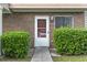 Close-up of front door #33, surrounded by lush green bushes and a well-maintained brick facade for added curb appeal at 86 Beaver Pond Loop # 33, Pawleys Island, SC 29585