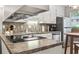 Efficient kitchen layout with stainless appliances, sleek cooktop, granite countertops, and ample cabinet space at 86 Beaver Pond Loop # 33, Pawleys Island, SC 29585
