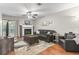 Bright living room boasts a brick fireplace, ceiling fan, hardwood floors, and access to the sunroom at 86 Beaver Pond Loop # 33, Pawleys Island, SC 29585
