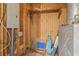 Unfinished storage area with plywood walls, electrical box, shelf and concrete floor at 86 Beaver Pond Loop # 33, Pawleys Island, SC 29585