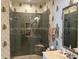 Modern bathroom featuring a tiled shower with a built-in niche and decorative wallpaper at 1000 Ray Costin Way # 114, Murrells Inlet, SC 29576