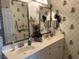 Bathroom with dual sinks, framed mirrors, and tropical wallpaper at 1000 Ray Costin Way # 114, Murrells Inlet, SC 29576