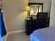 A bedroom featuring a black dresser, mirror, and nautical decor at 1000 Ray Costin Way # 114, Murrells Inlet, SC 29576