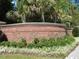 Elegant brick sign amidst lush greenery marking the entrance to Tupelo Bay Golf Villas at 1000 Ray Costin Way # 114, Murrells Inlet, SC 29576